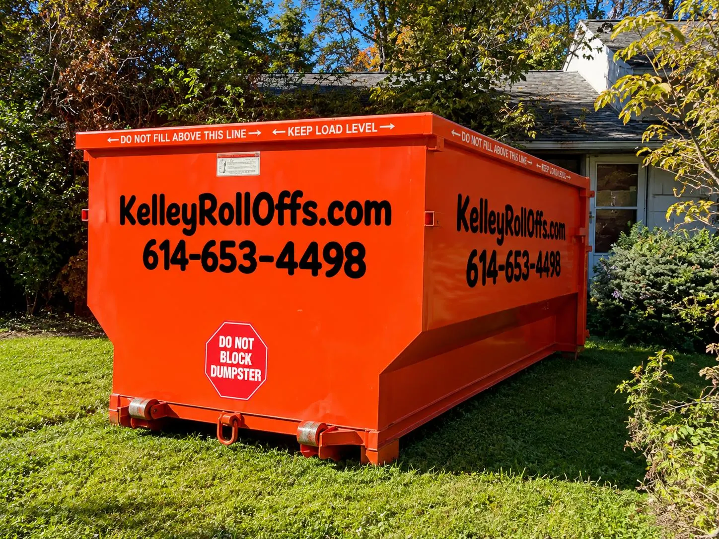 Orange Kelley Roll-Offs dumpster with the company phone number